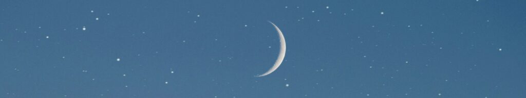 crescent moon above mountain