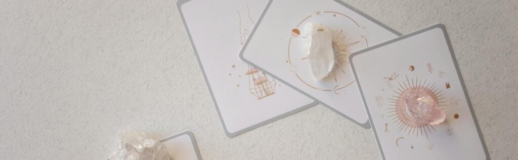 Mystical tarot cards paired with healing crystals on a serene surface, embracing spirituality.