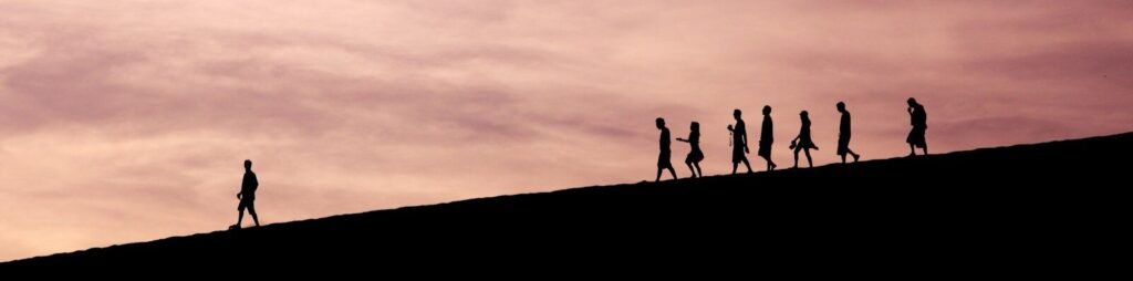 silhouette of people on hill