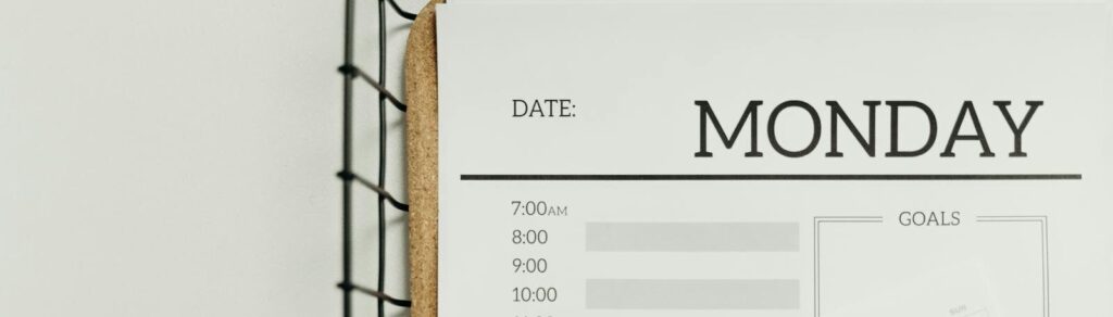 Top view of a minimalist schedule planner with Monday header. Perfect for organizing daily tasks with goals section.