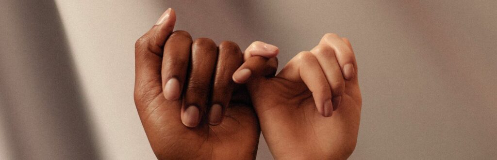 persons hand with white manicure