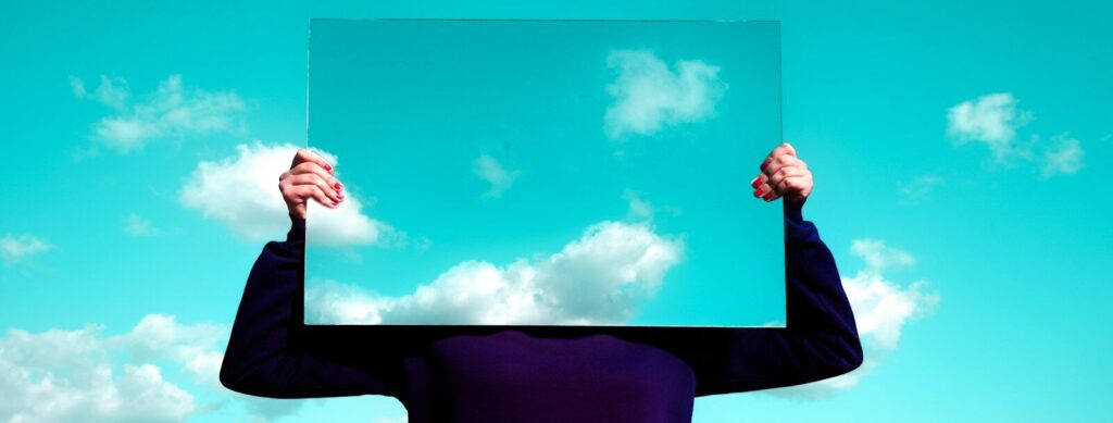 man in black suit jacket raising his right hand