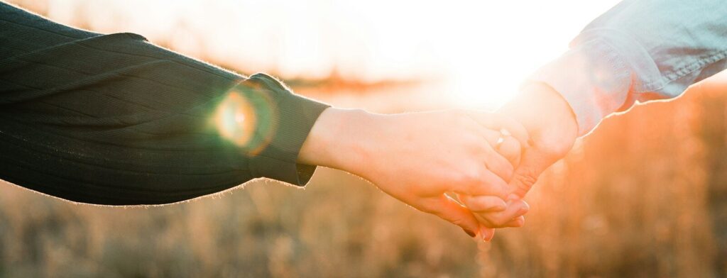 two person holding each other's hands