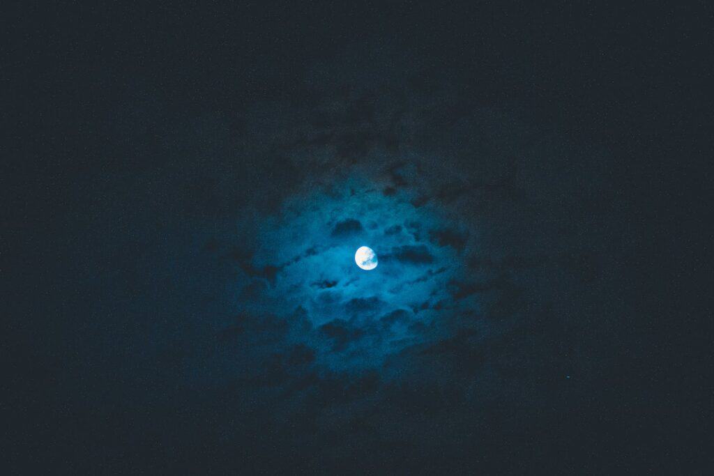 Moon shining on dark sky
