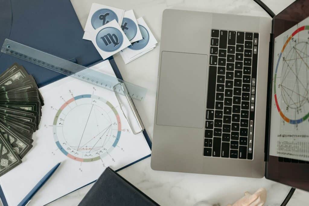 Horoscope Cards and Laptop on a Table