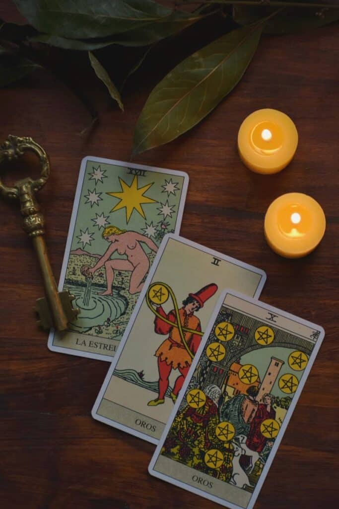 Mystical tarot card reading setup with candles and an antique key. Horoscope Insights