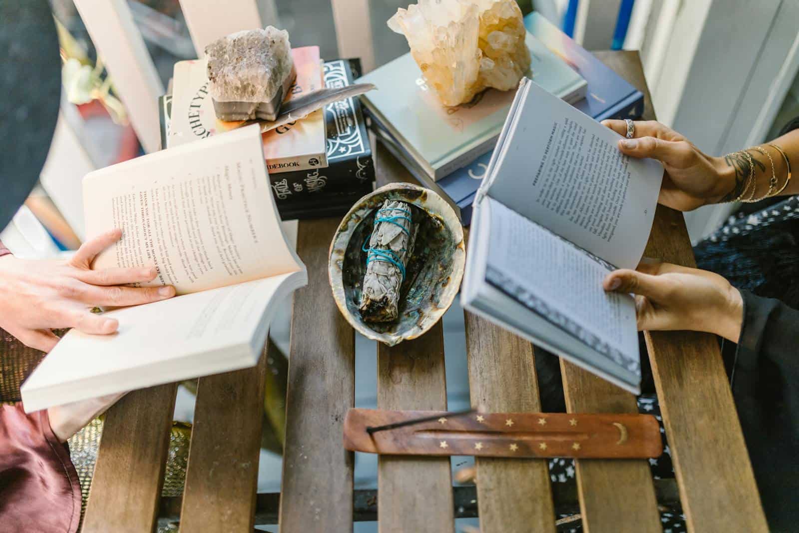 A cozy indoor setup for spiritual reading and crystal healing with books, crystals, and incense. horoscope