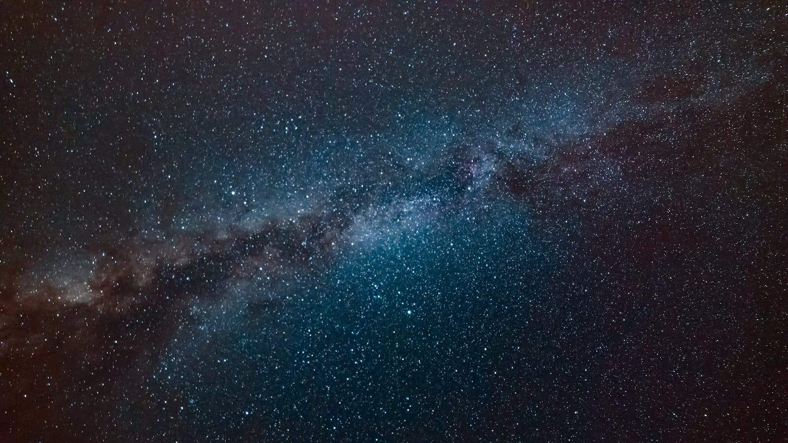 Astrological Transits, A stunning view of the Milky Way galaxy filling the night sky, showcasing countless stars.