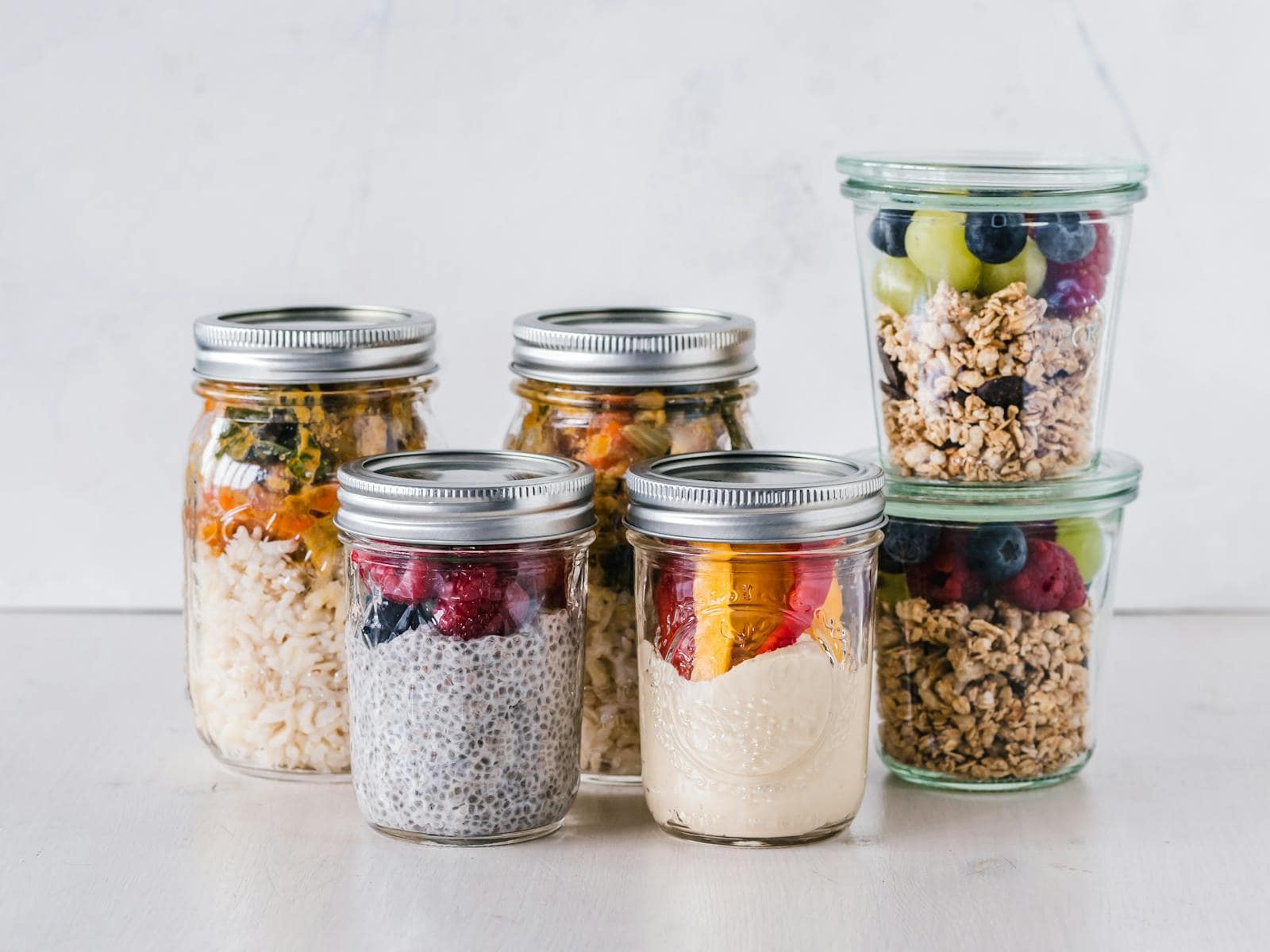 Close-up of healthy food jars containing granola, fruits, and yogurt. probiotics, gut health, ibs, leaky gut