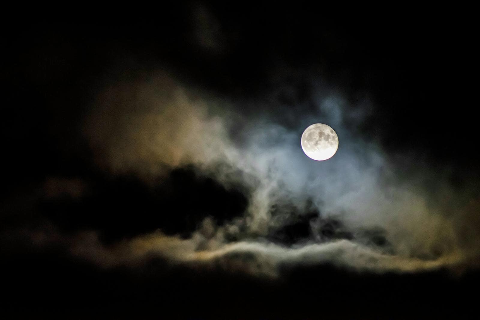 Moon signs, astrology, zodiac, horoscope, astrology, A full moon illuminates the night sky, shrouded by eerie clouds creating a spooky atmosphere.