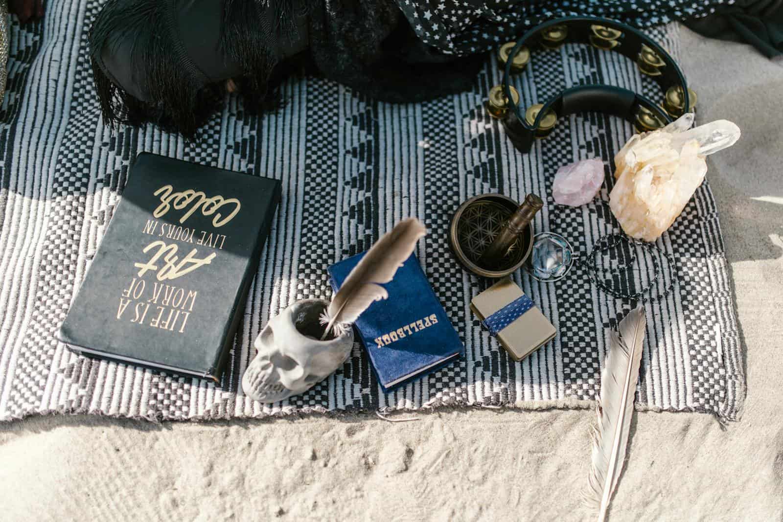 Zodiac Love Compatibility: Finding Your Perfect Match, earth signs, astrology, Flat lay of spiritual tools with crystals, skull cup, and feathers on a blanket outdoors.
