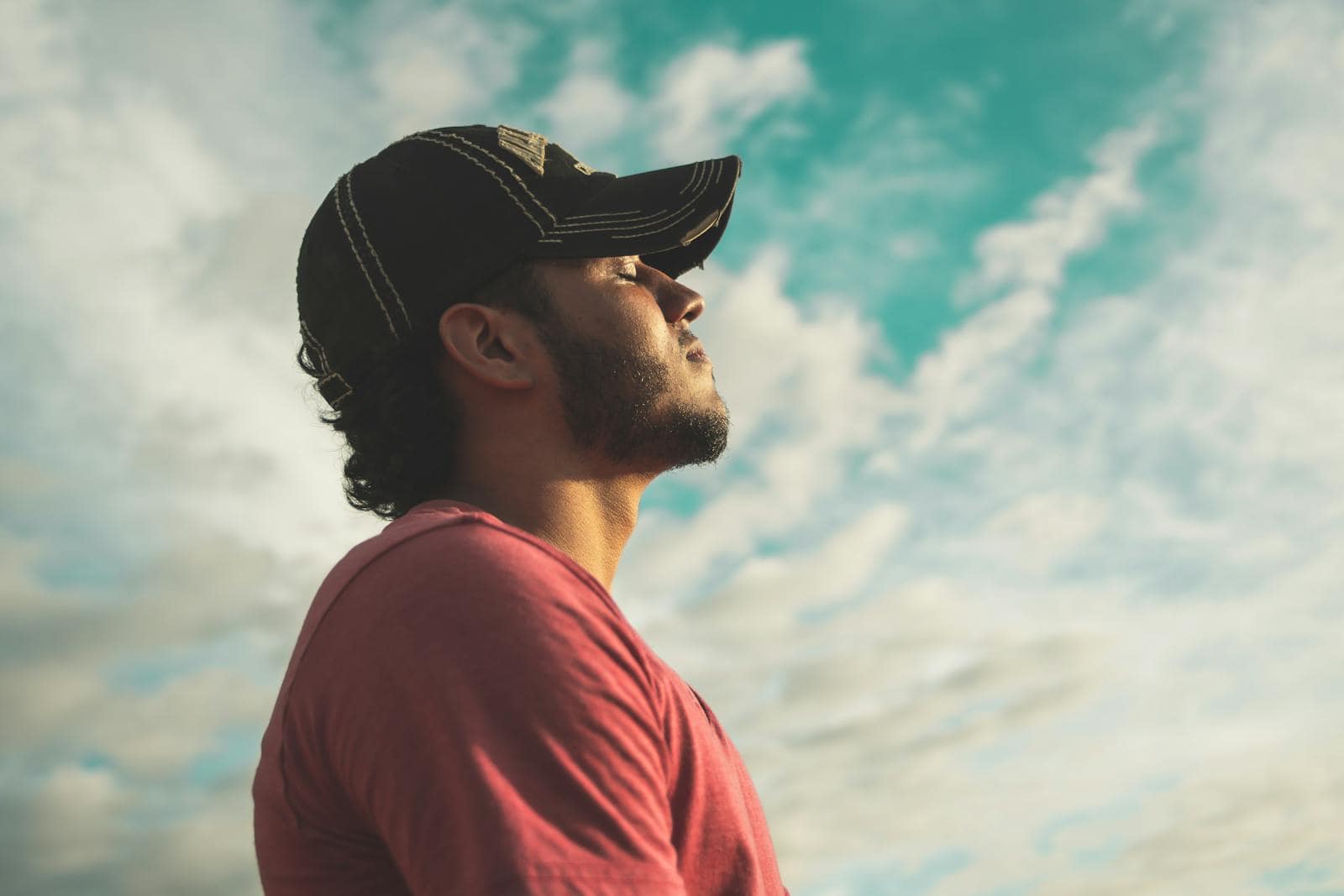 Birth Chart Reading, Astrology, Zodiac, A man enjoys outdoor relaxation and mindfulness beneath a bright, cloudy sky, exuding calm and peace.