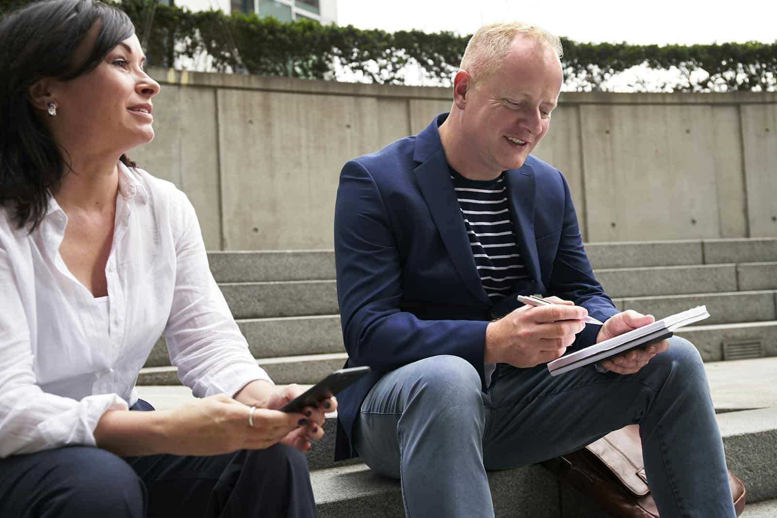 fire sign, astrology, horoscope, zodiac, leo, prediction, future, A man and woman engage in a work-related discussion outdoors in London.