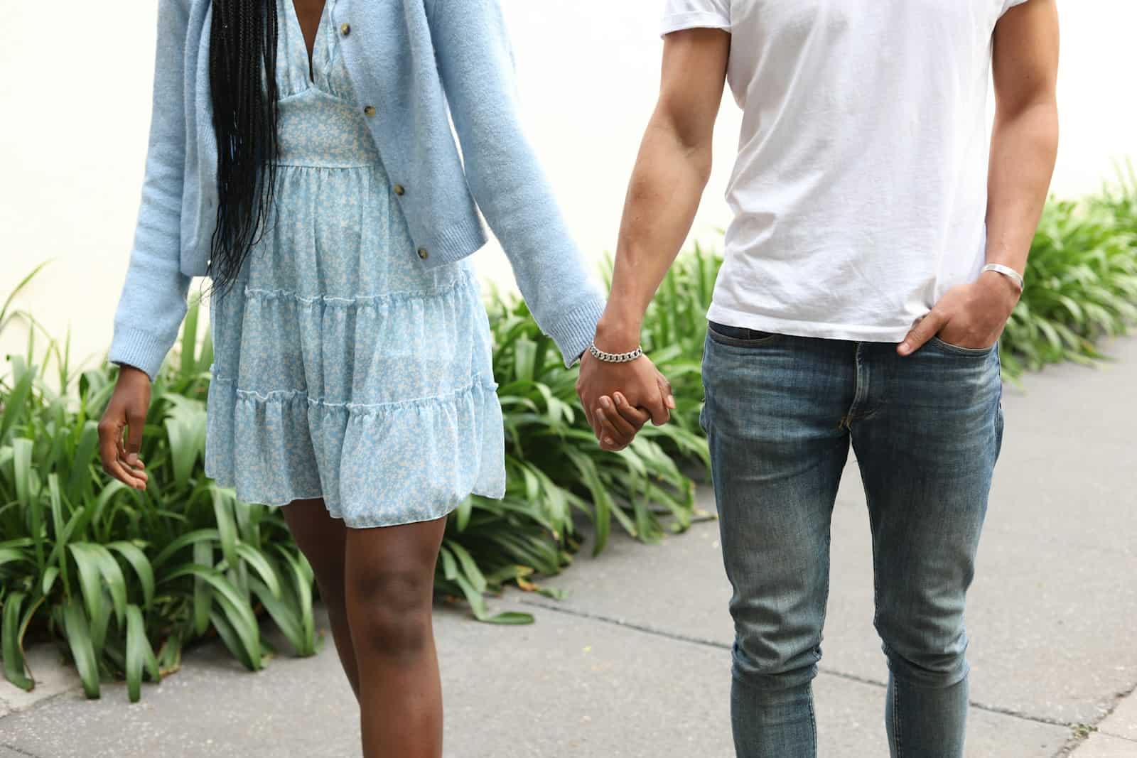 a man and a woman holding hands walking down a sidewalk, Kundali Love Matches, Horoscope, Astrology, Natal Chart, Birth Chart, Celestial Guidance