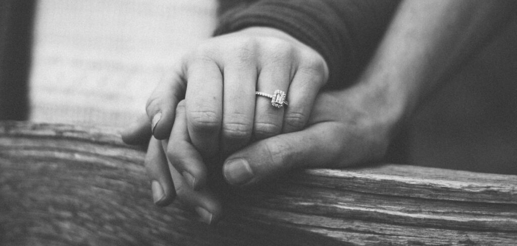 a couple holding hands with a wedding ring visible, astrology, love, relationship, horoscope, future predictions, zodiac
