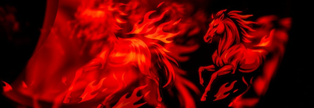 Two fiery horses running in the dark