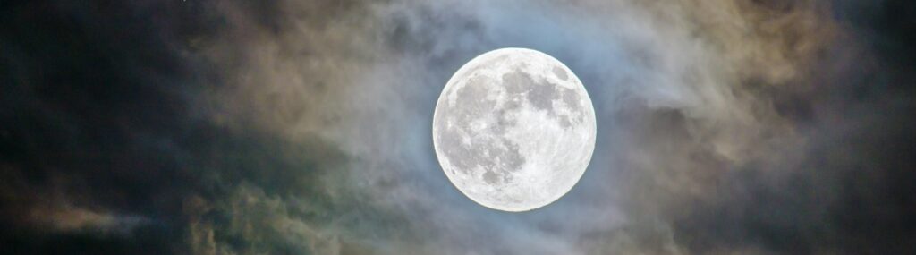 full moon and gray clouds during nighttime